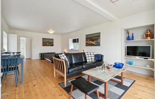 a living room with a couch and a table at 1 Bedroom Amazing Apartment In Rønne in Rønne