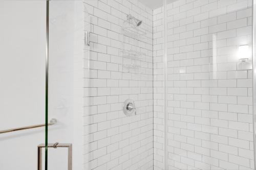 a white tiled shower with a glass door at Mt Vernon Studio w Pool WD Gym nr Metro WDC-530 in Washington, D.C.