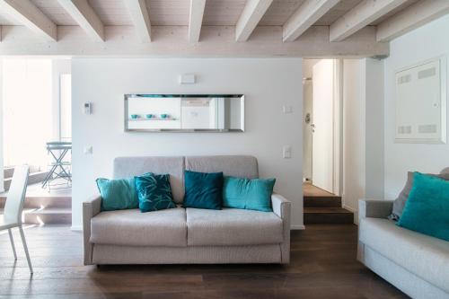 a living room with a couch and blue pillows at Il Balcone sul Lago by Quokka 360 - historic lakeside flat in Morcote in Morcote