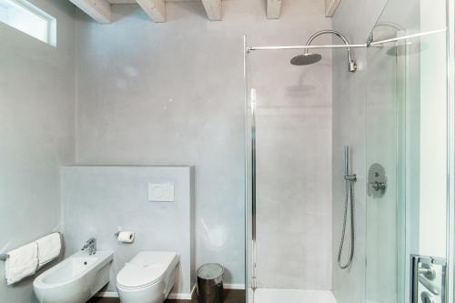 a bathroom with a shower and a toilet and a sink at Il Balcone sul Lago by Quokka 360 - historic lakeside flat in Morcote in Morcote
