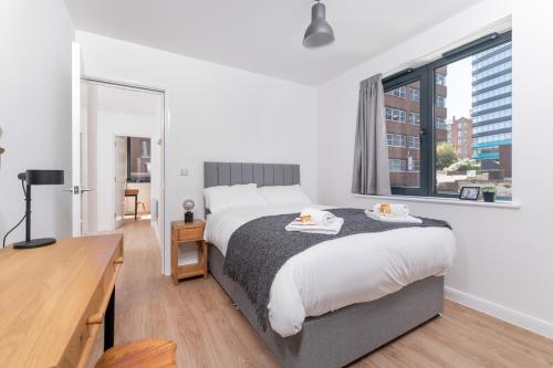 a bedroom with a large bed and a large window at 123 Queen Street - Home Crowd Luxury Apartments in Sheffield