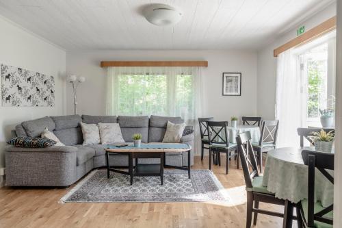 a living room with a couch and a table at Vandrarhemmet Stranden in Mora