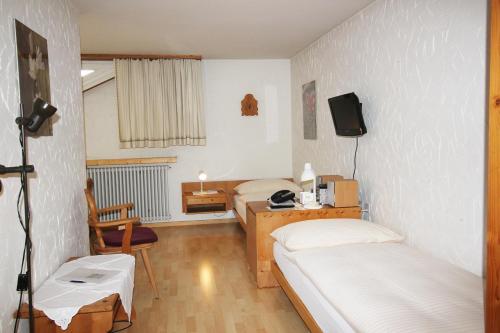 una camera con 2 letti, una scrivania e una TV di Residenza Lagrev Studio Nr 224 - Typ 10B - 2 Etage - Ost a Sils Maria