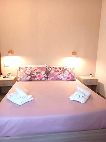 a bedroom with a bed with two towels on it at La Casa Di Lucia in San Vito Chietino
