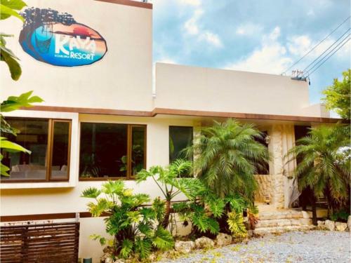 a building with a sign on the side of it at KAYA RESORT KOURIJIMA - Vacation STAY 95302v in Kouri