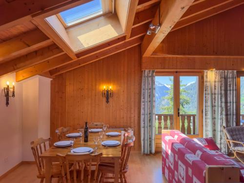 a dining room with a table and a couch at Apartment Baudrier A28 by Interhome in Verbier