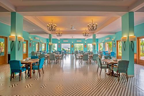 a dining room with tables and chairs at Ratan Villas Sariska in Alwar