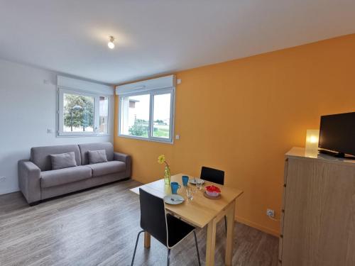 a living room with a table and a couch at Studio Apsara by Interhome in Saint Malo