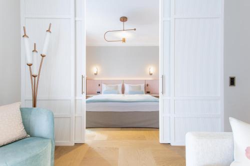a bedroom with a bed and a blue couch at Art Deco Hotel Montana Luzern in Luzern