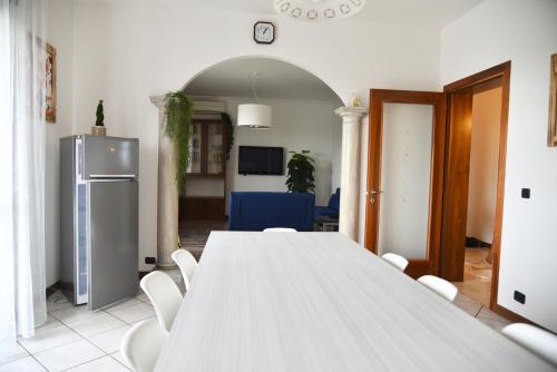 a large white table and chairs in a room at Ornella's apartment - Relax near Venice in Boion
