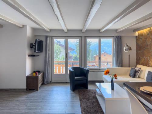a living room with a couch and a table at Apartment Stem 2 by Interhome in Verbier