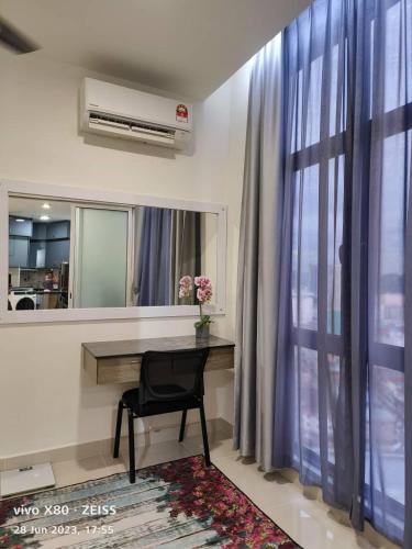 a desk with a chair in a room with a mirror at Qilala DualView by The Shore in Kota Kinabalu