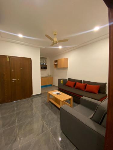 a living room with a couch and a table at Mayama Residences in Accra