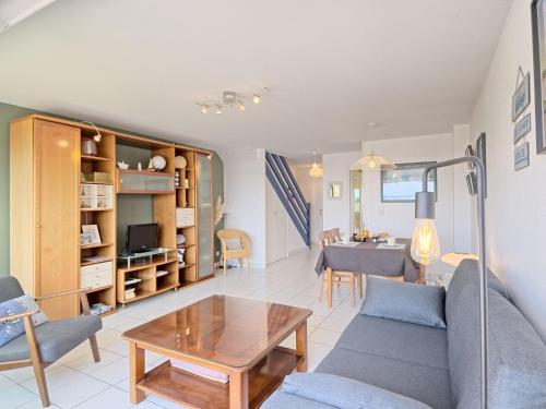 a living room with a couch and a table at Apartment Belle Vue Mer et Groix by Interhome in Ploemeur