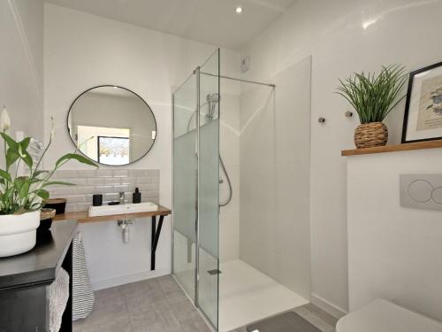 a bathroom with a glass shower and a sink at Holiday Home Ker Bernic by Interhome in Piriac-sur-Mer