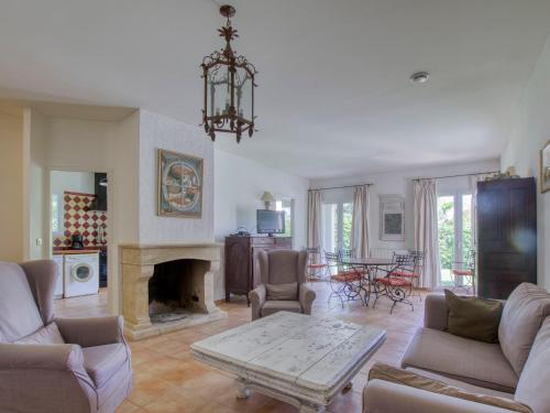 a living room filled with furniture and a fireplace at Villa Le Puit des Oliviers I by Interhome in La Cadière-dʼAzur