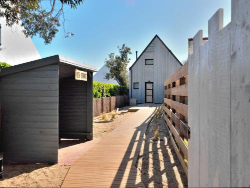 a house with a garage and a fence at Holiday Home Ker Bernic by Interhome in Piriac-sur-Mer