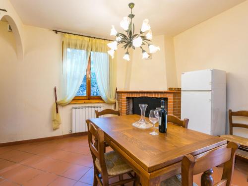 a dining room with a wooden table and a fireplace at Holiday Home Lavanda by Interhome in Badia Agnano