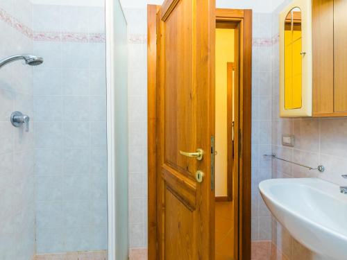 a bathroom with a shower and a wooden door at Holiday Home Lavanda by Interhome in Badia Agnano