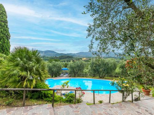 a swimming pool in a garden with a view at Holiday Home San Lazzaro by Interhome in Montevettolini