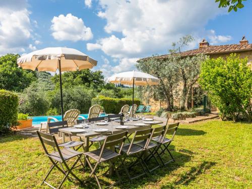 Pergine ValdarnoにあるHoliday Home Il Laghetto by Interhomeの庭のテーブル(椅子、パラソル付)