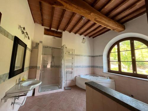 y baño con bañera, ducha y lavamanos. en Villa Bella Costa, en Monticello