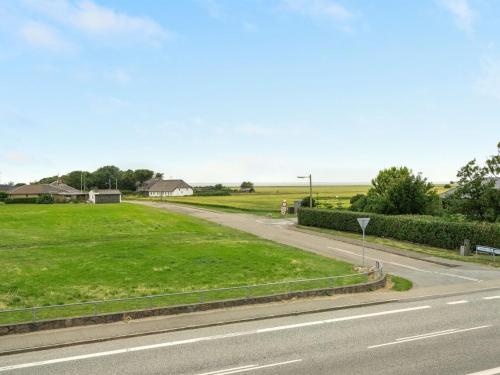 a road leading down to a field of grass at Holiday Home Saga by Interhome in Bredebro