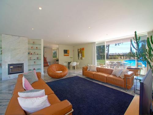a living room with two couches and a fireplace at Holiday Home Villa Golf by Interhome in Portimão