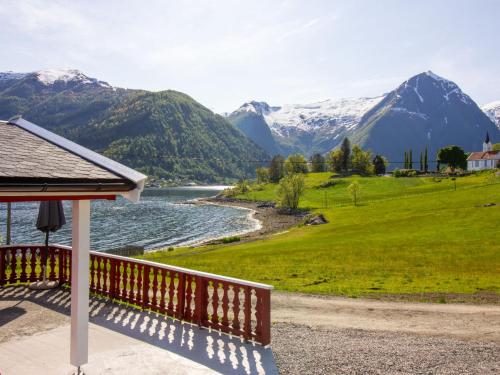 a porch with a view of a river and mountains at Holiday Home Naustvollen - FJS123 by Interhome in Balestrand