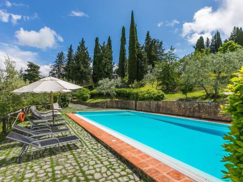 an image of a swimming pool with chairs and an umbrella at Holiday Home San Rocco-2 by Interhome in Greve in Chianti