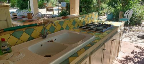 a kitchen counter with a sink and a stove at Villa Novella in Le Beausset