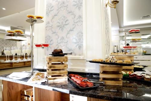 a buffet in a hotel with food on a counter at Amman Paradise Hotel in Amman