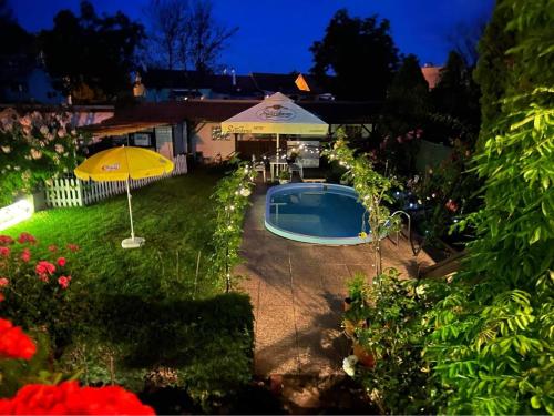 a backyard with an umbrella and a swimming pool at Ubytovani Na Hrazi 91 in Znojmo