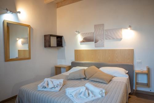 a bedroom with a bed with towels on it at B&B Alle Calende Greche in Martignano