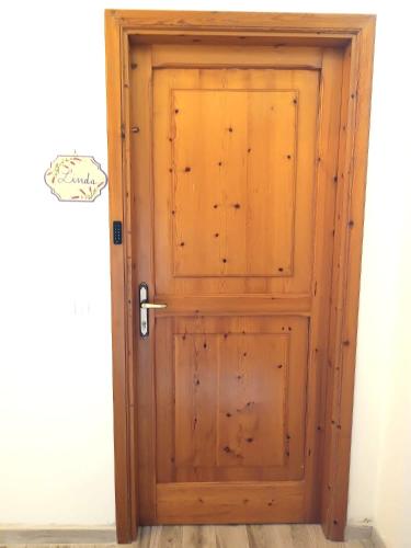 a wooden door in the corner of a room at La Casa Di Lucia in San Vito Chietino