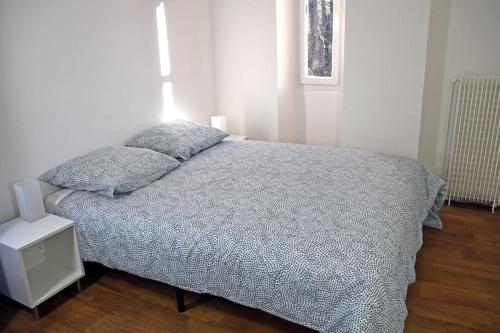 ein Schlafzimmer mit einem Bett mit zwei Kissen darauf in der Unterkunft F4 MimiPinson 1er étage Rabinon lac riviere VAR in Le Muy