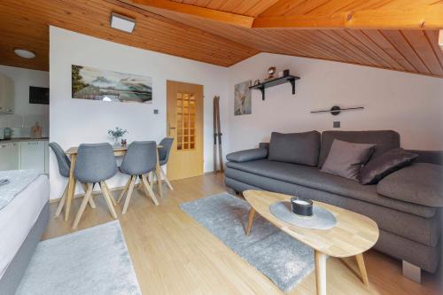 a living room with a couch and a table at Apartma Alpine Space, Kranjska Gora - Center in Kranjska Gora