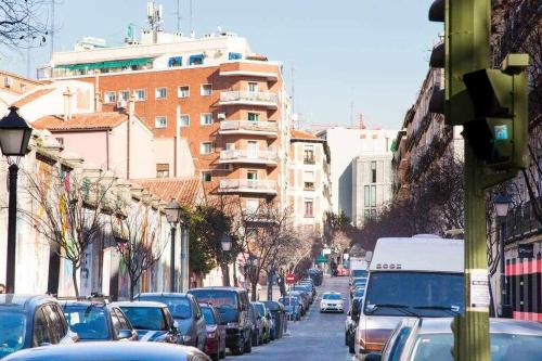 マドリードにあるComodo Y Agradable Apartamento En Madrid Centro 3の車や建物が多く並ぶ賑やかな街並み
