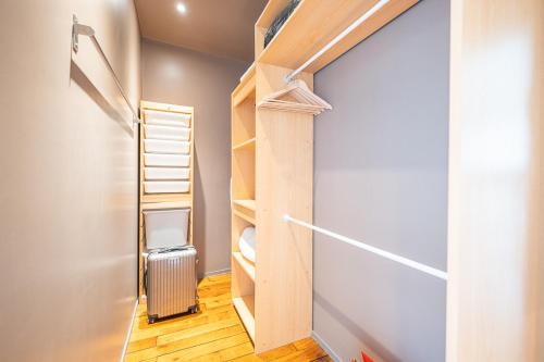 a small room with a ladder and a closet at Bastille Trousseau Apartment in Paris