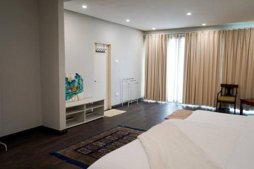 a bedroom with a large white bed in a room at Luxury One Villa - In the heart of Petaling Jaya in Petaling Jaya