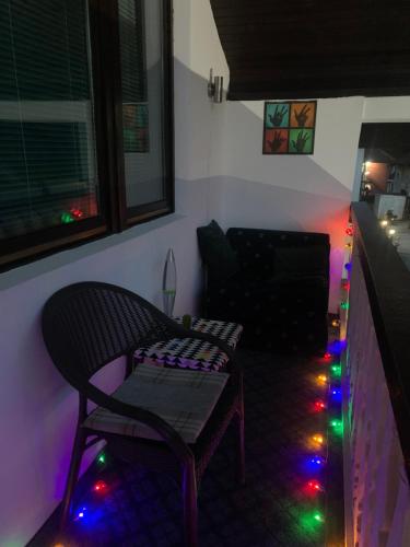 a living room with a chair and a couch with christmas lights at VIP Rooms Foča, Accommodation Foca, Foca Rooms in Foča