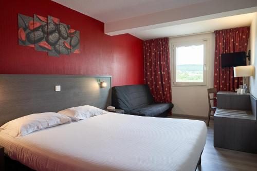 a hotel room with a bed and a chair at Authentic by balladins Dijon / Marsannay-la-Côte in Marsannay-la-Côte