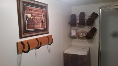 a bathroom with a wooden bench and a picture on the wall at Lonesome Dove Ranch in Kalispell