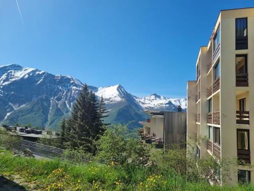 a view of snow covered mountains from a building at Studio Cosy Plein Soleil in Orcières