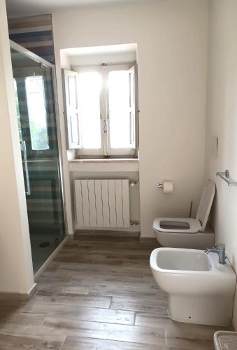 a bathroom with a toilet and a sink and a shower at La Casa Di Lucia in San Vito Chietino