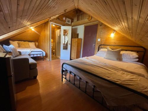 a bedroom with two beds in a attic at Three Peaks Banff in Banff