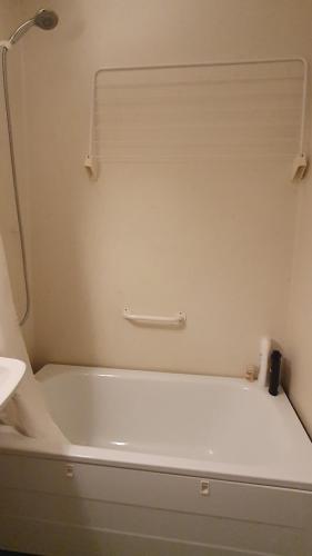 a white bath tub in a bathroom with a window at Apartment in Södertälje Stockholm in Södertälje
