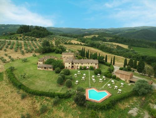 an aerial view of a large estate with a group of tables at Fattorie Santo Pietro in San Gimignano