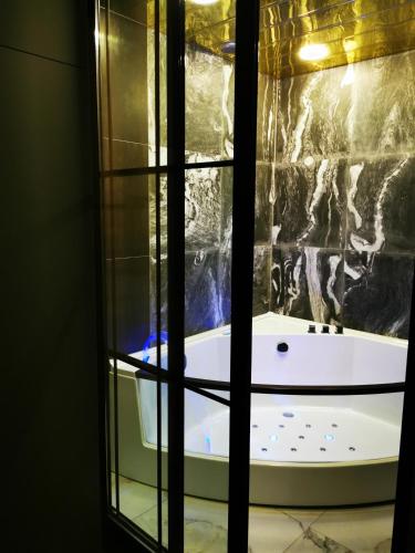 a bath tub in a room with a window at City Center Cozy 3Bedroom Apartment with Unique Design and Hot Tub , 2Bathroom, Middle of Center, By Republic Square in Yerevan