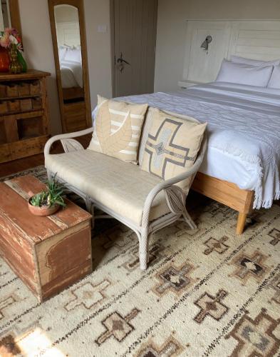 a bedroom with a bed and a chair and a table at No12 in Mansle